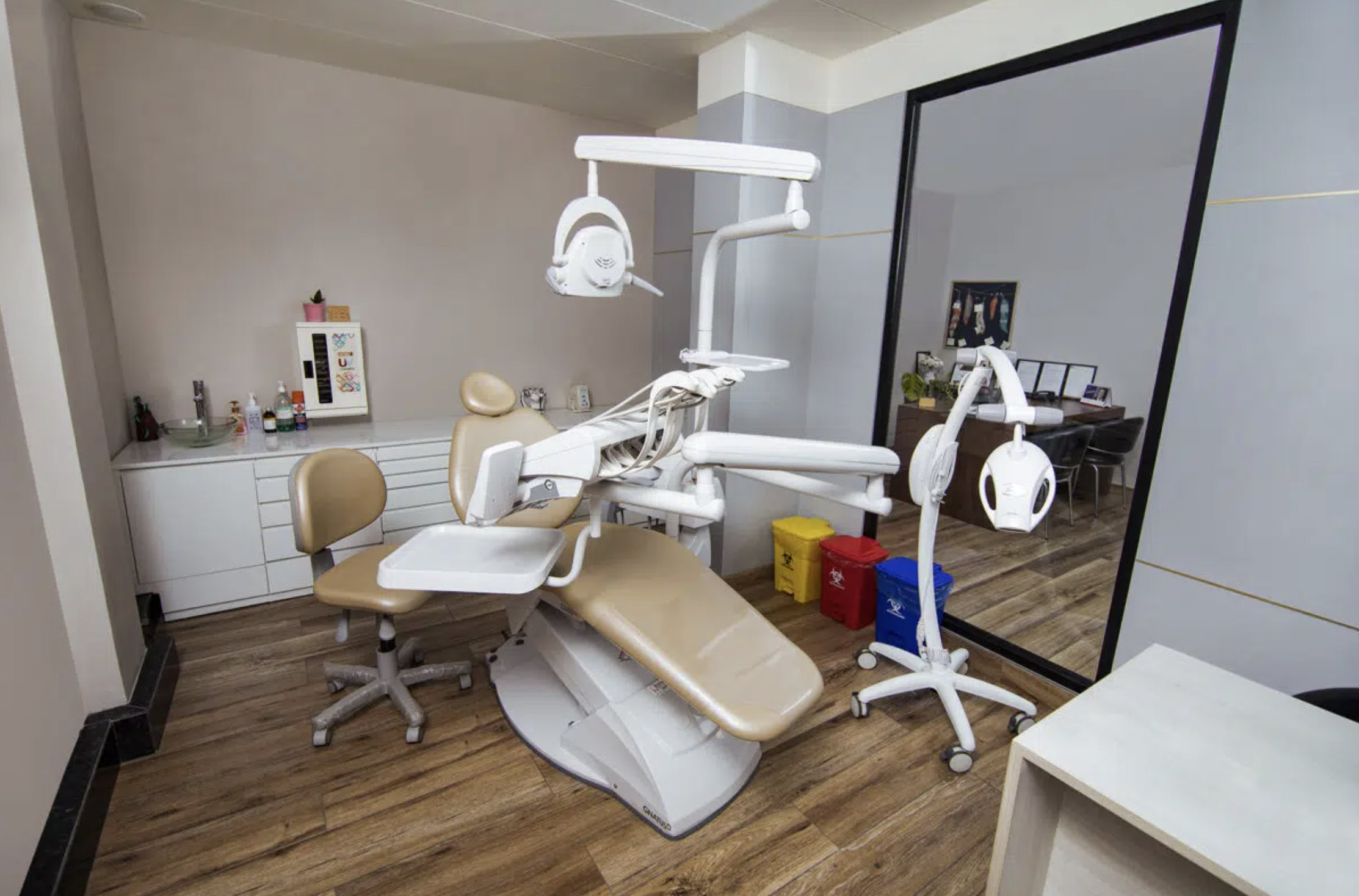 Dental operatory with chair and clinical equipment.
